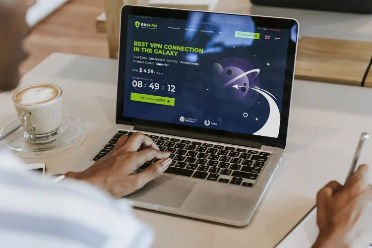 Remote worker using VPN and password manager to protect digital security on laptop