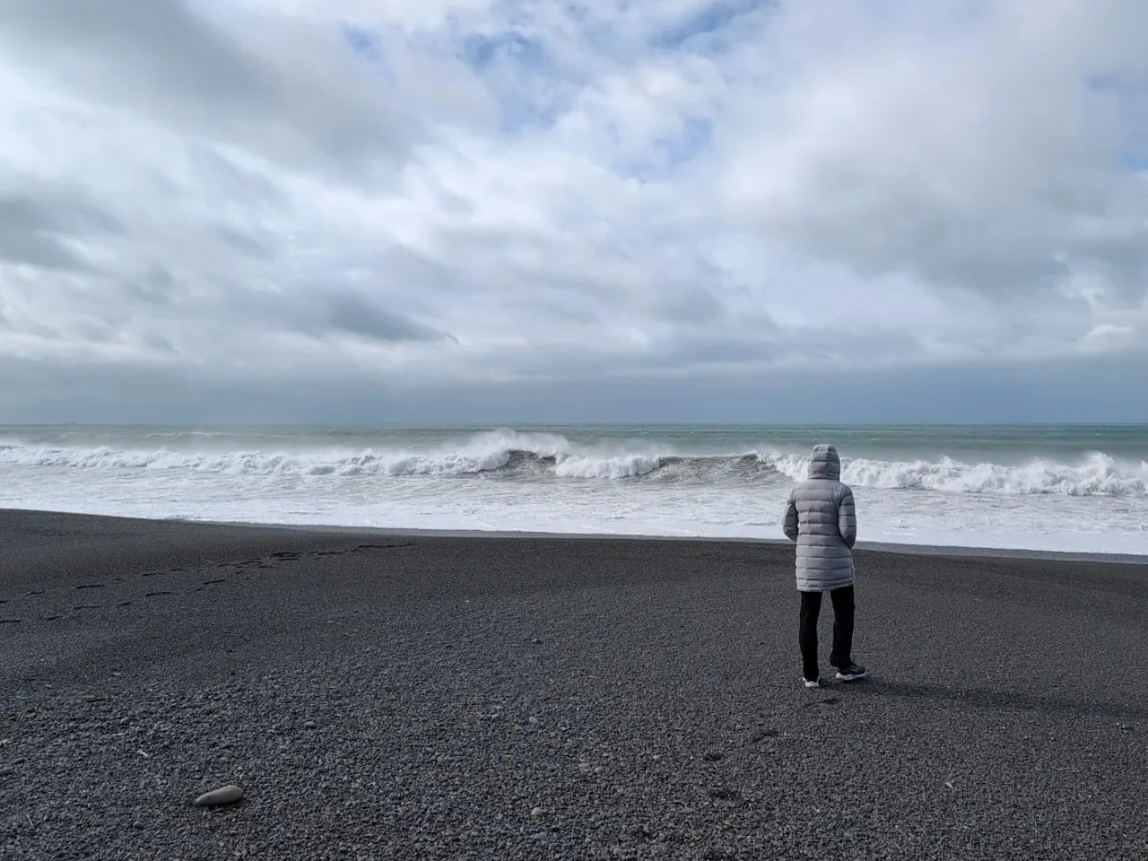 Going analogue - Beach and rough ocean with woman looking at ocean in foreground